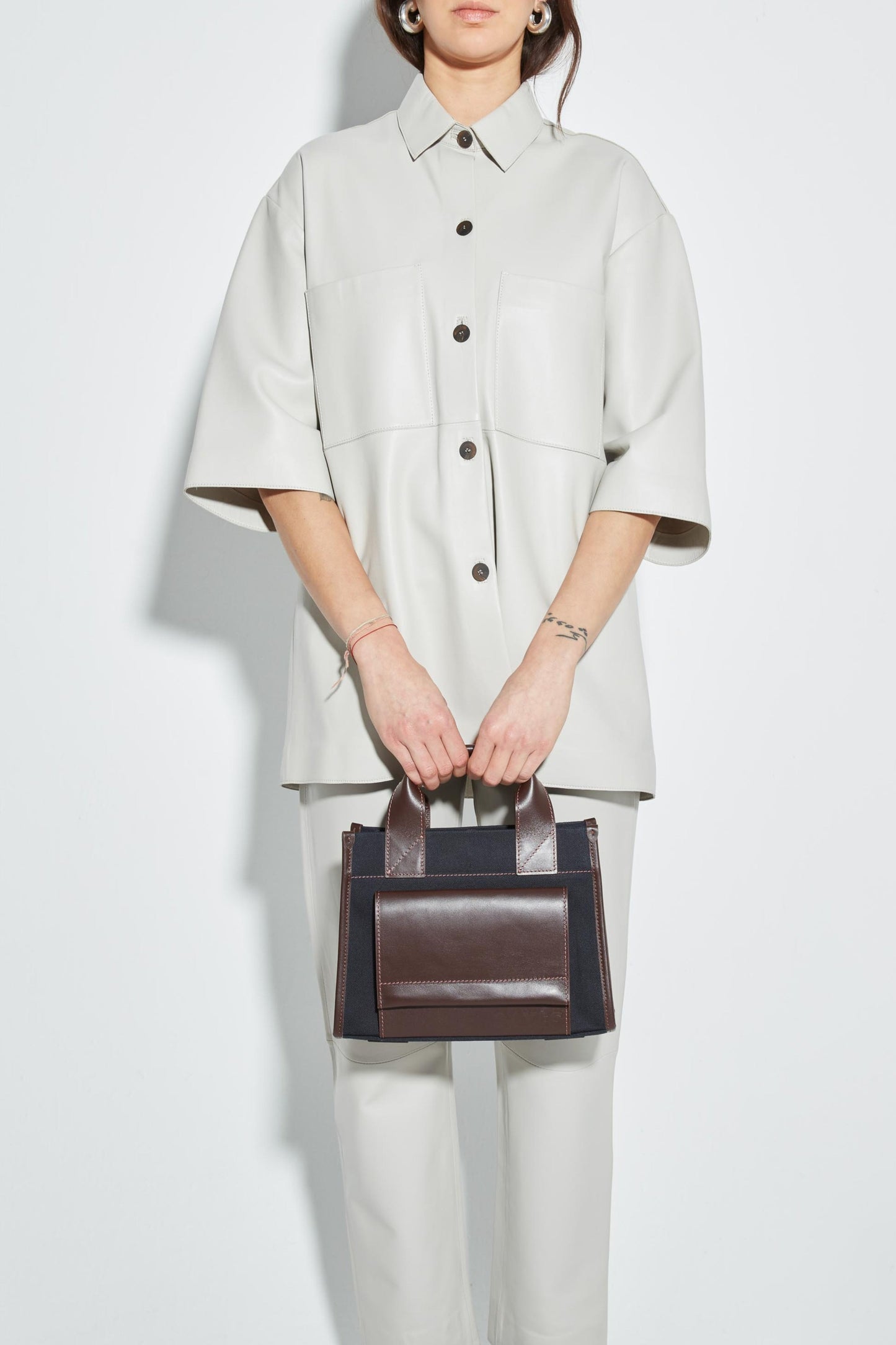 STITCHED POCKET MINI TOTE IN NAVY AND BROWN