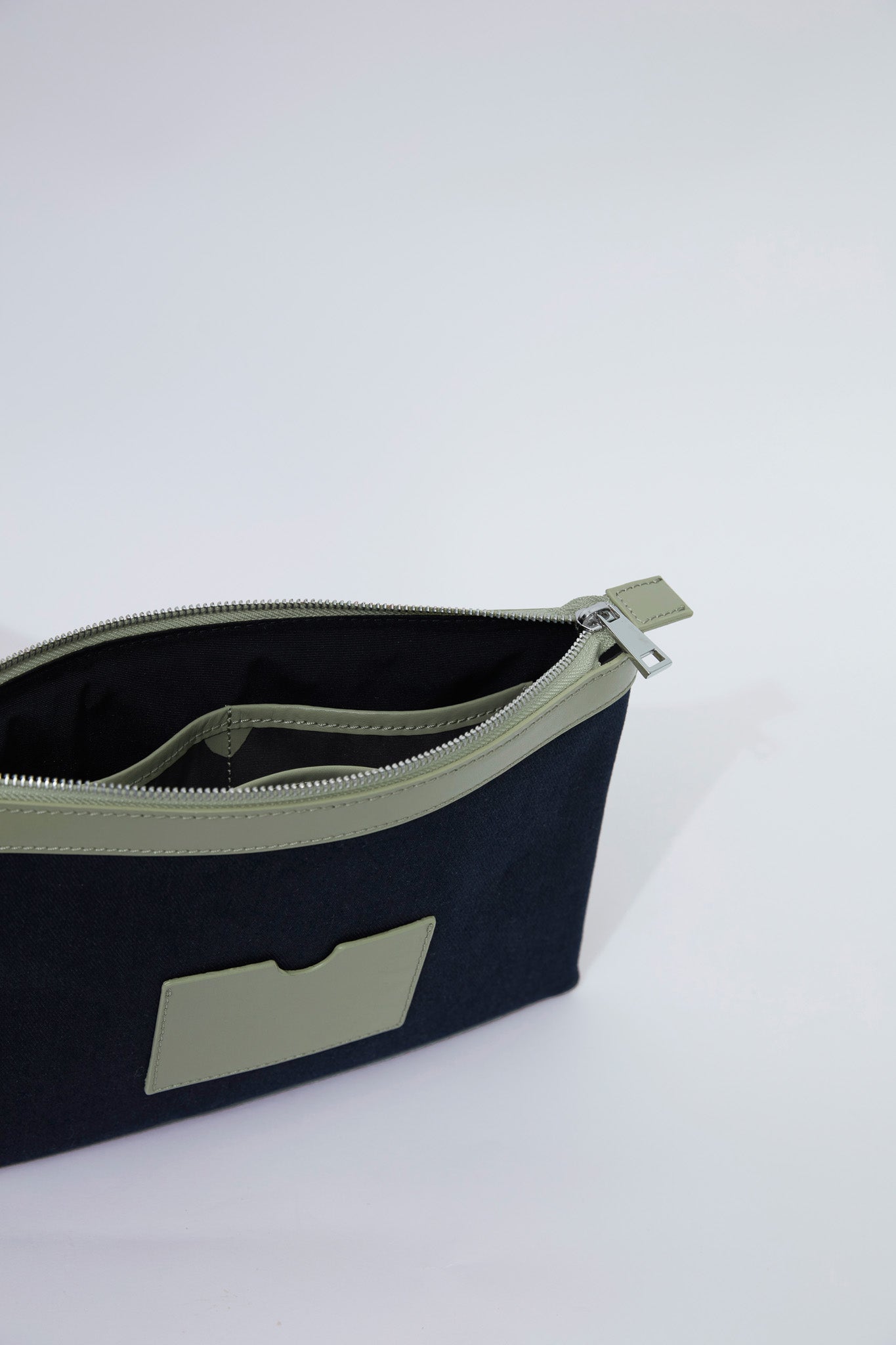 STITCHED CLUTCH IN NAVY AND OIL GREEN