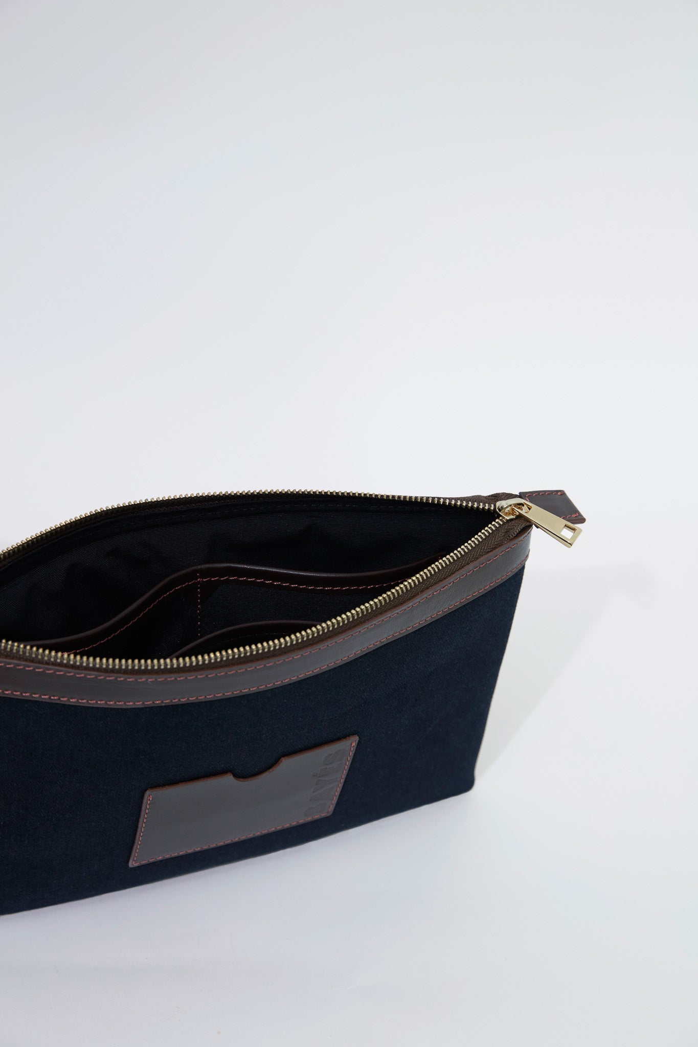STITCHED CLUTCH IN NAVY AND BROWN