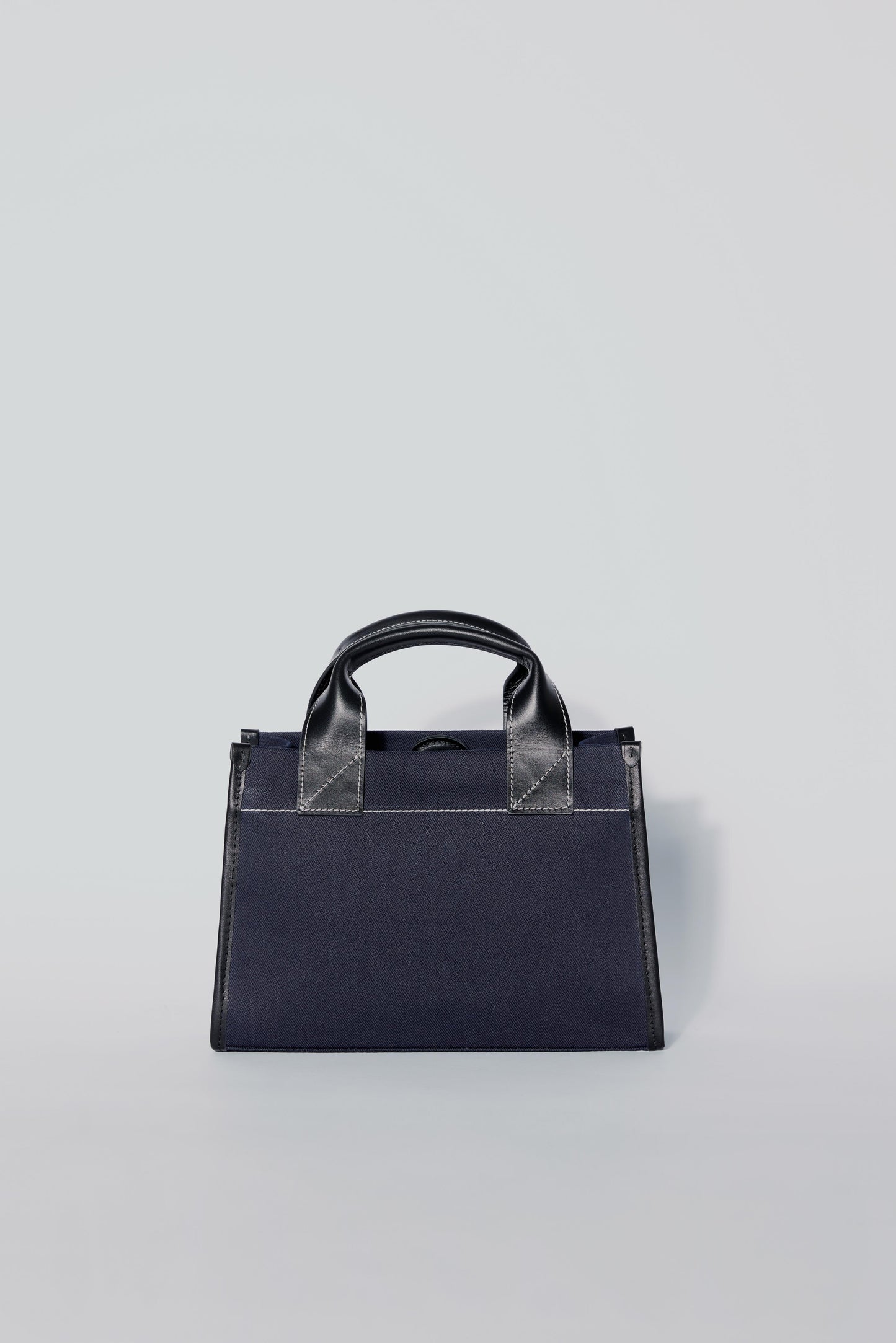 STITCHED POCKET MINI TOTE BAG IN NAVY AND BLACK
