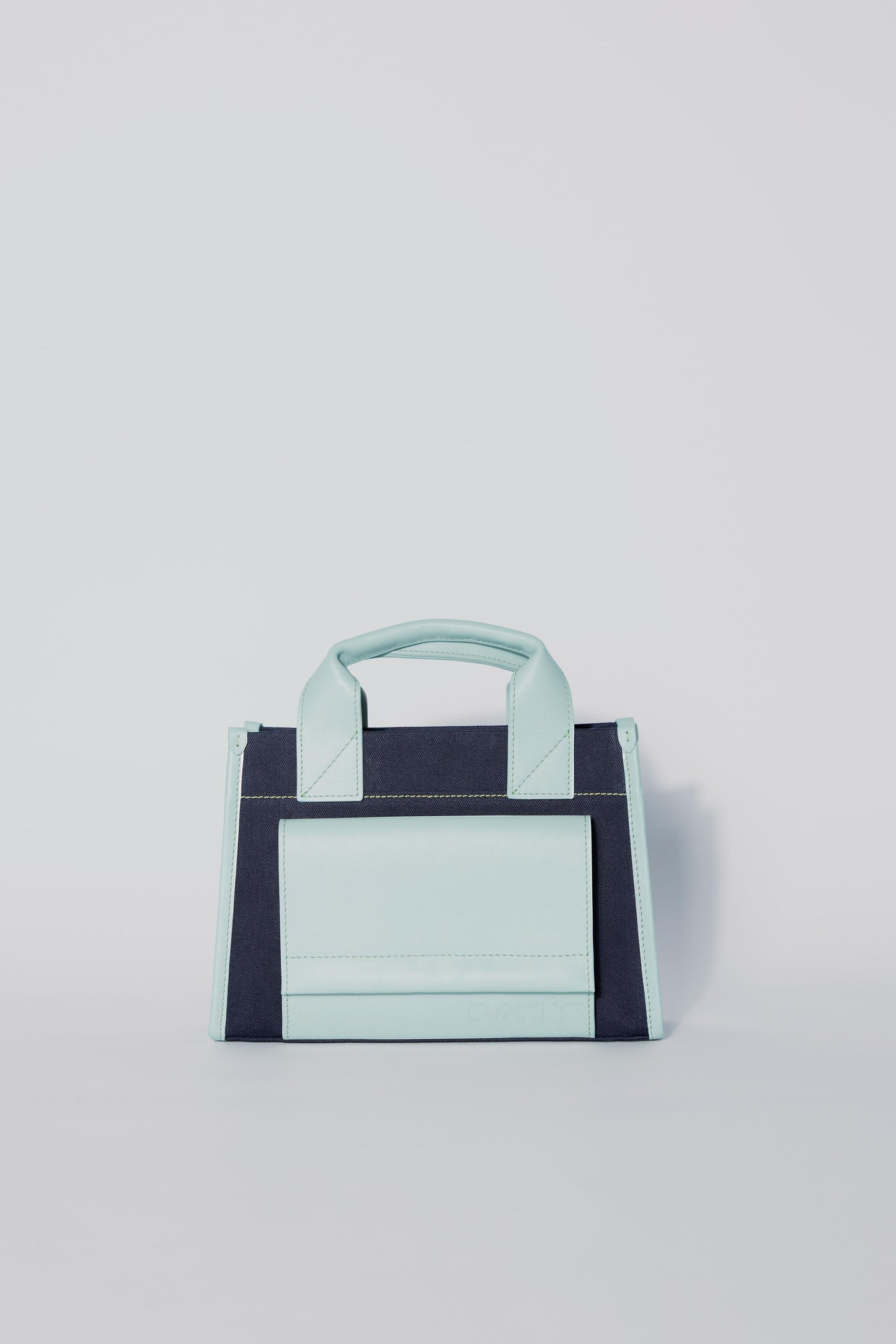 STITCHED POCKET MINI TOTE BAG IN NAVY AND SEA GREEN