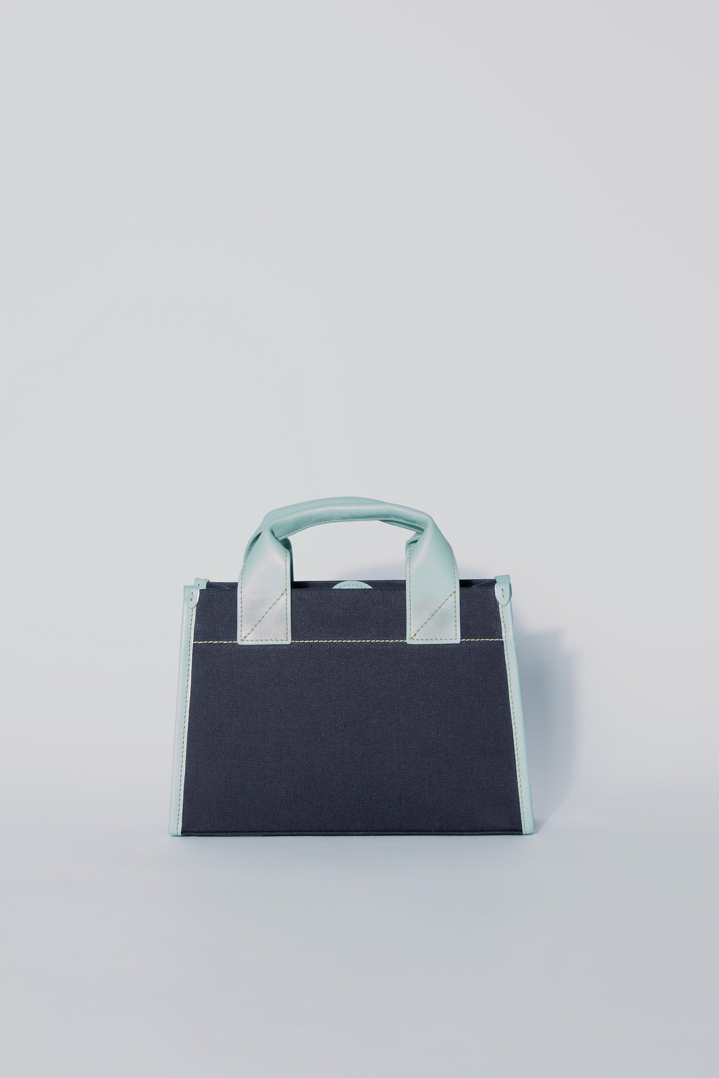 STITCHED POCKET MINI TOTE BAG IN NAVY AND SEA GREEN