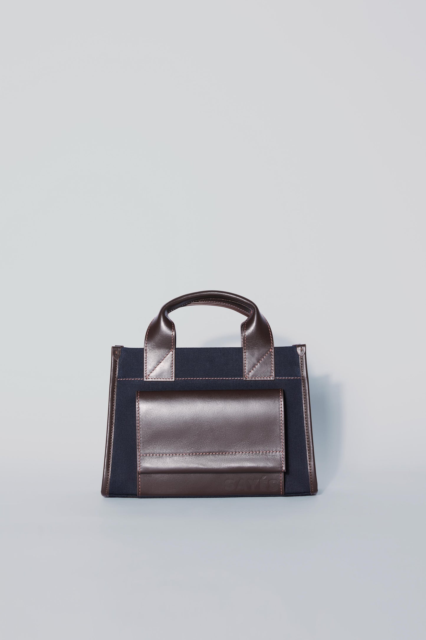 STITCHED POCKET MINI TOTE IN NAVY AND BROWN