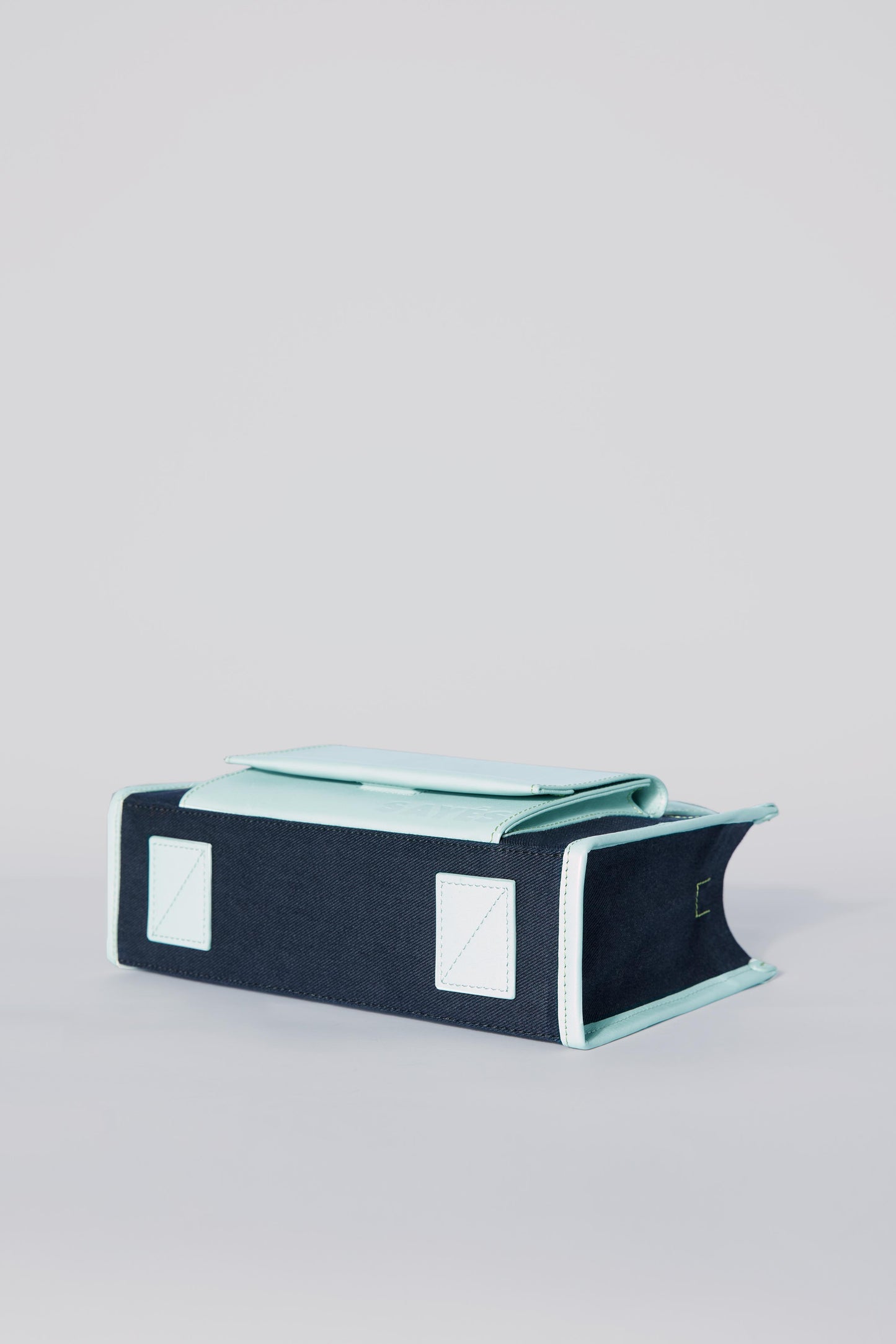 STITCHED POCKET MINI TOTE BAG IN NAVY AND SEA GREEN
