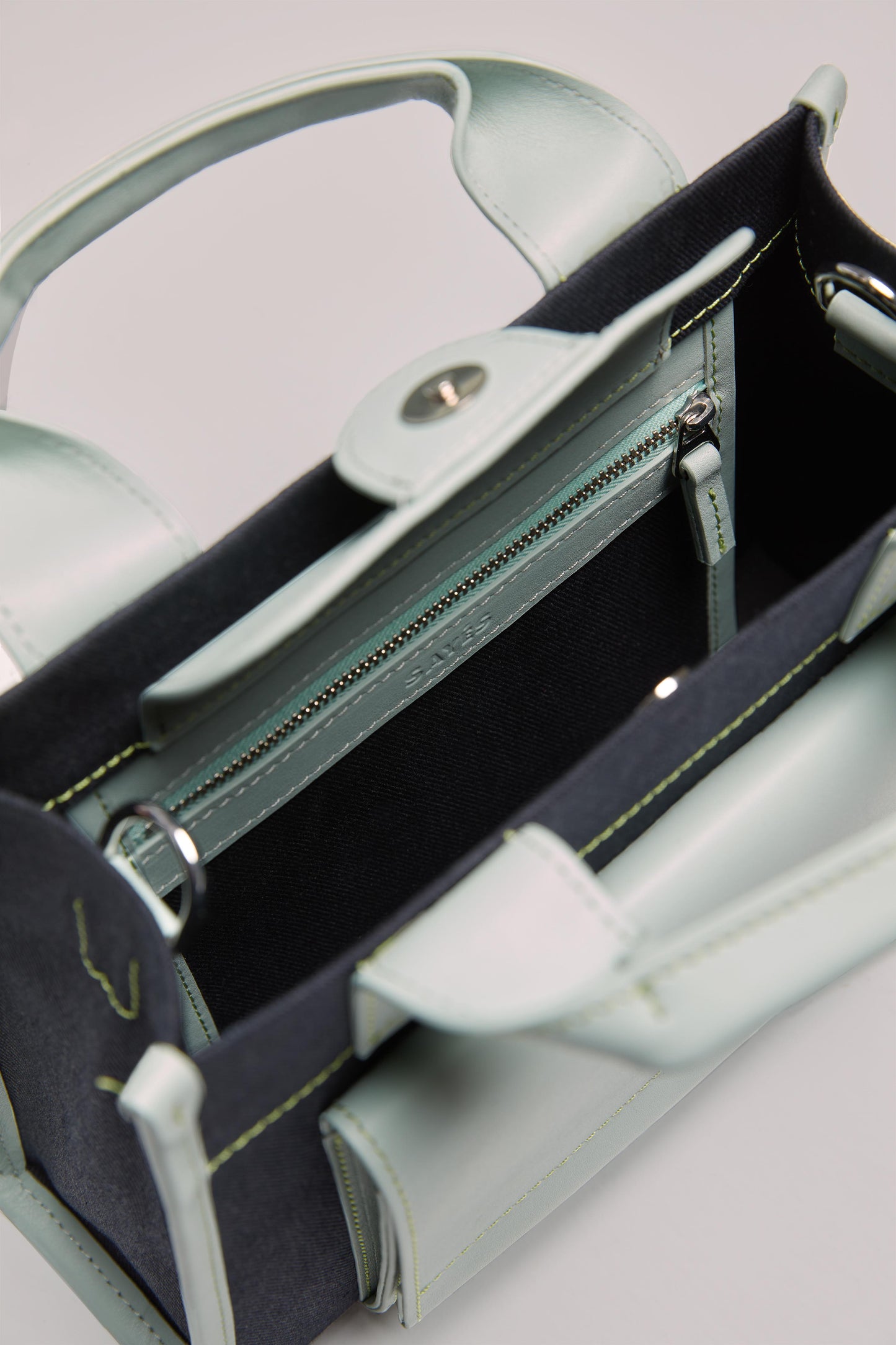 STITCHED POCKET MINI TOTE BAG IN NAVY AND SEA GREEN