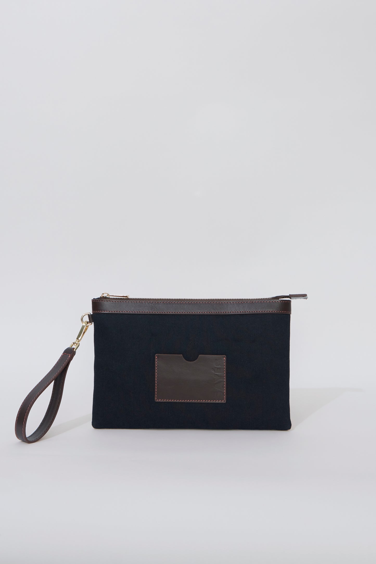 STITCHED CLUTCH BAG IN NAVY AND BROWN