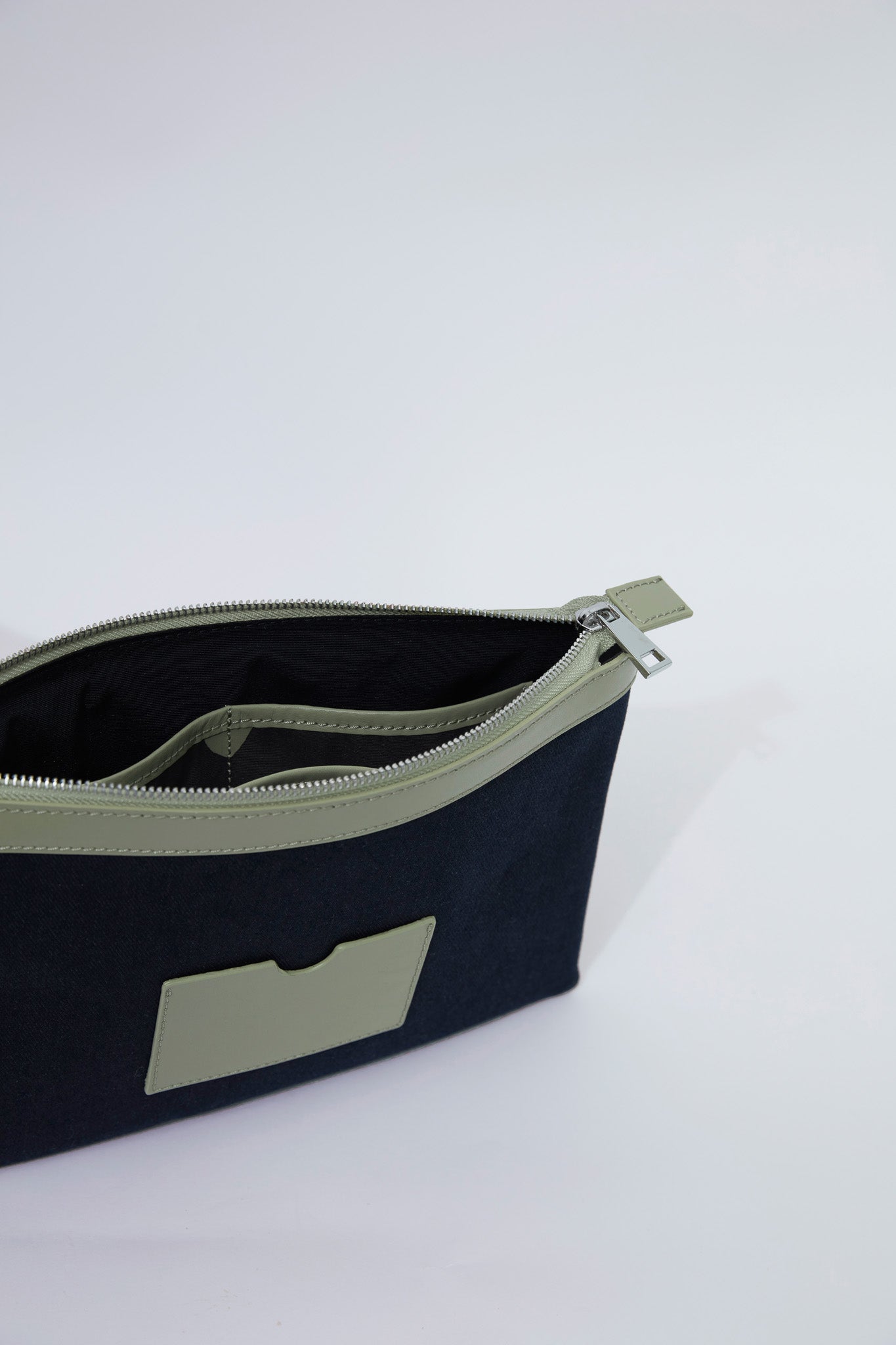 STITCHED CLUTCH BAG IN NAVY AND OIL GREEN