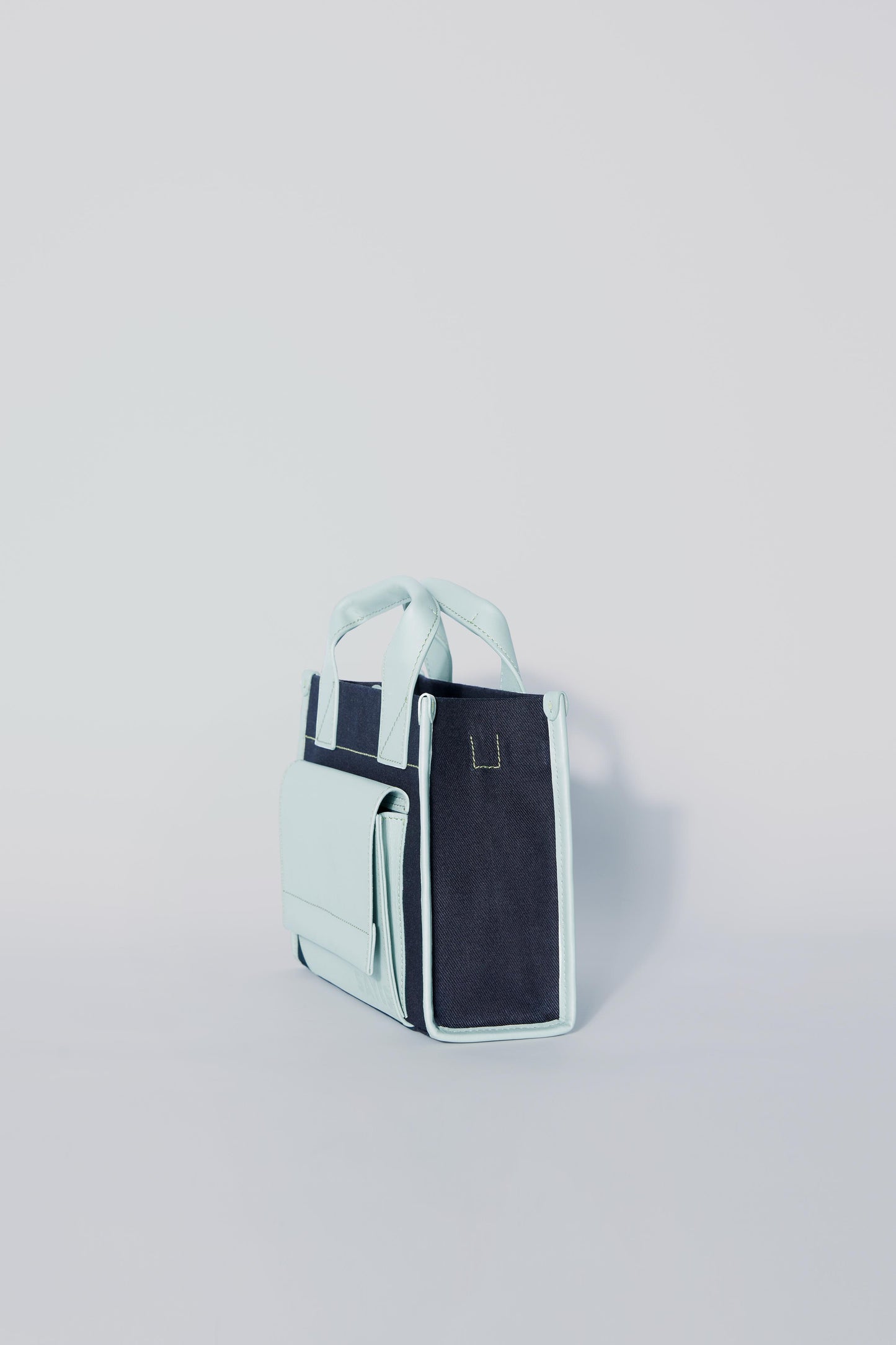 STITCHED POCKET MINI TOTE BAG IN NAVY AND SEA GREEN