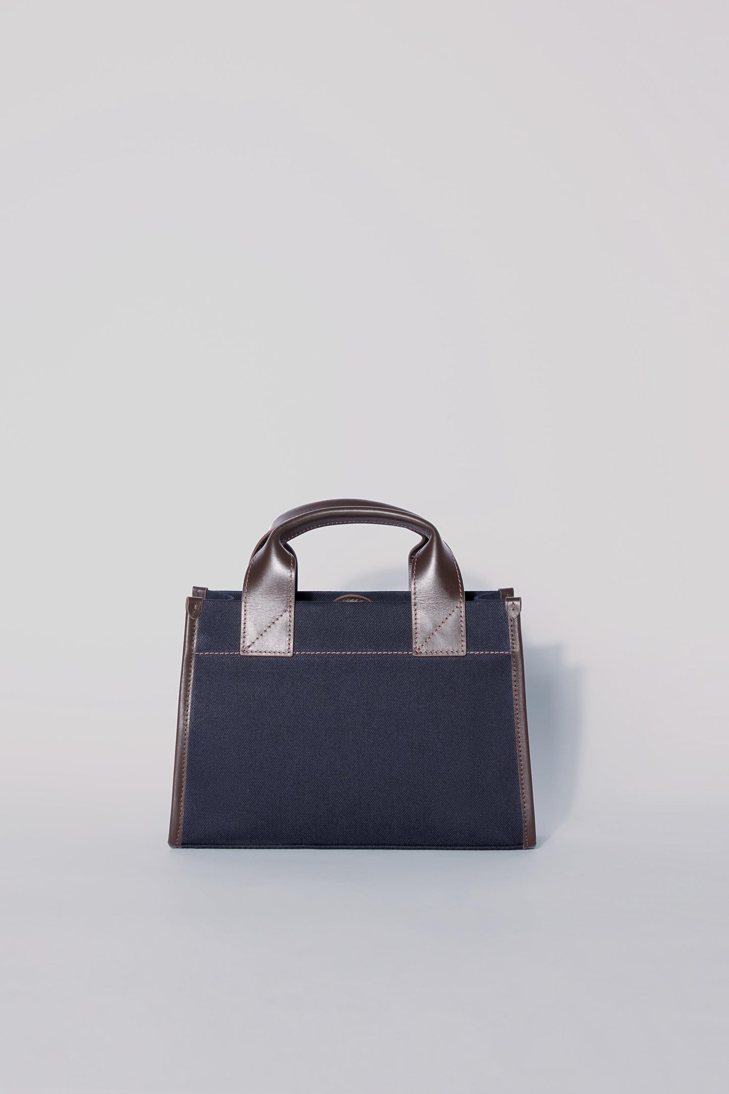STITCHED POCKET MINI TOTE IN NAVY AND BROWN